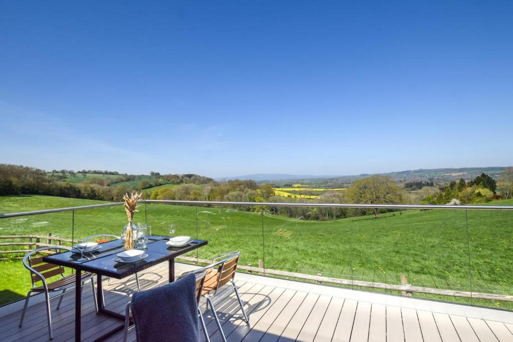 a patio with a table and chairs on a deck at 2 Bed in Bromyard oc-91816 in Collington