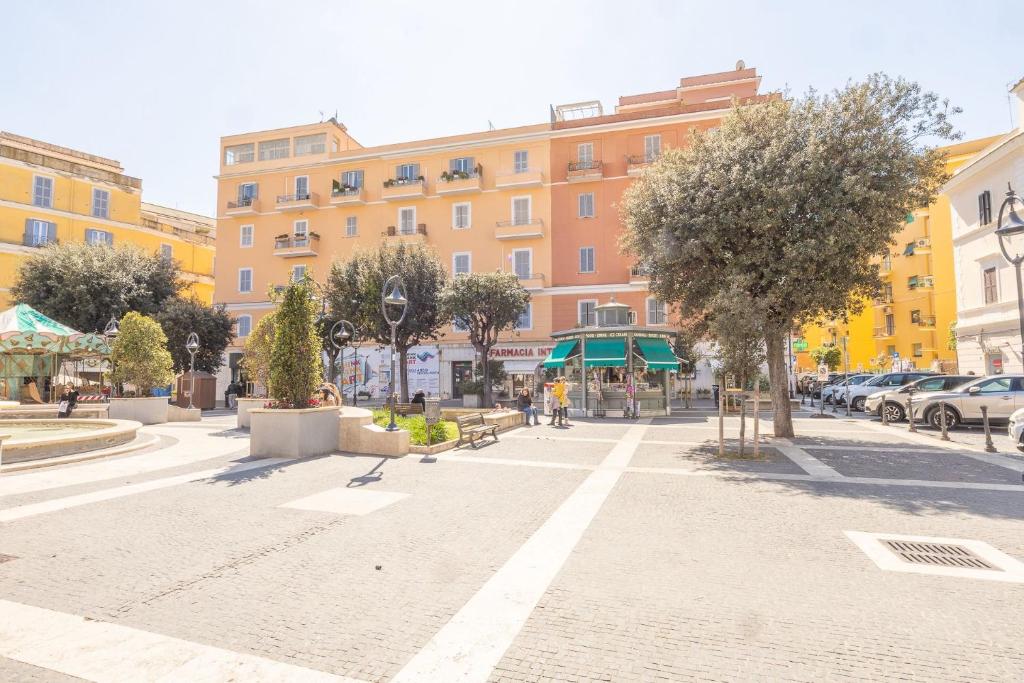 a street in a city with a large building at Piazza Pia Suites in Anzio