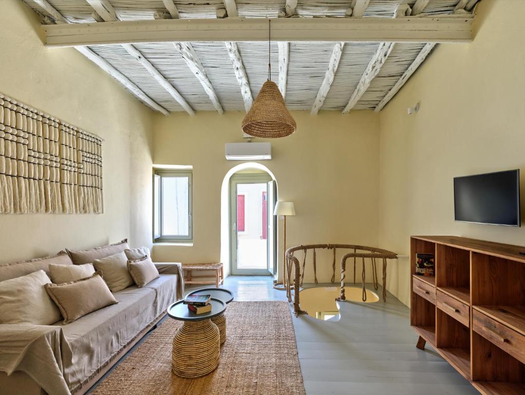 a living room with a couch and a table at Flair Naousa in Naousa
