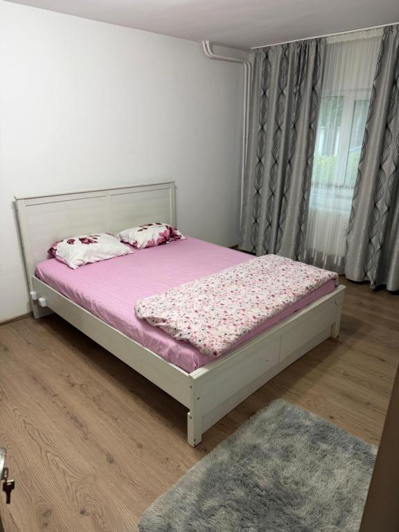 a bedroom with a bed with pink sheets and a purple mattress at Studio in Drobeta-Turnu Severin