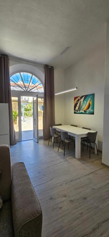 a living room with a white table and chairs at Blue Living -Archi di Mare in Marciana Marina