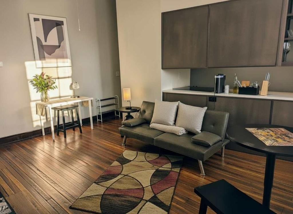 a living room with a couch and a kitchen at Modern Downtown Loft Walk to Convention Center in Richmond