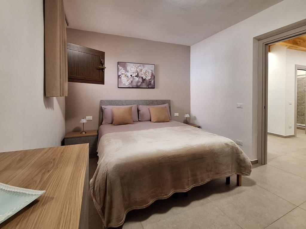 a bedroom with a large bed in a room at La Casa Sotto il Campanile in Sciacca