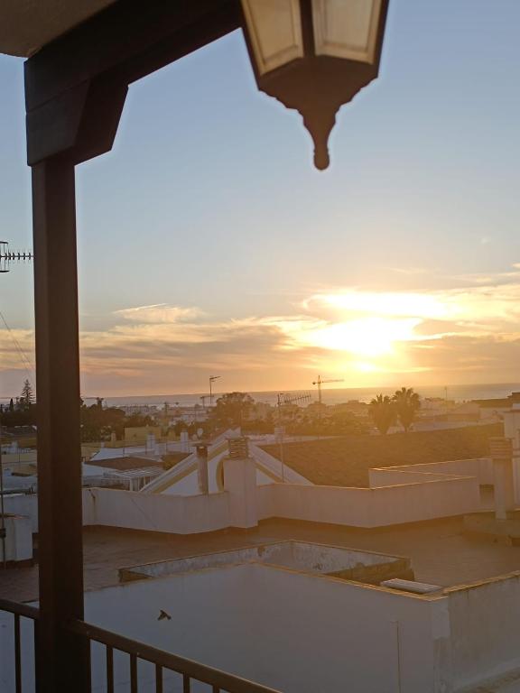 a view of the sunset from the balcony of a building at Ático luminoso con terraza privada in Sanlúcar de Barrameda