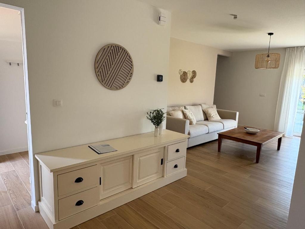 a living room with a couch and a table at De Boomgaard in Nieuwerkerken