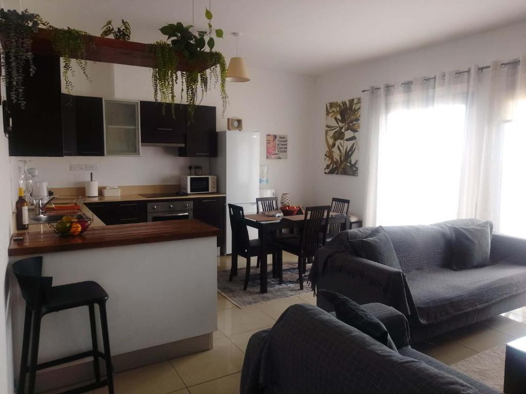 a kitchen and living room with a couch and a table at corali in Tersephanou