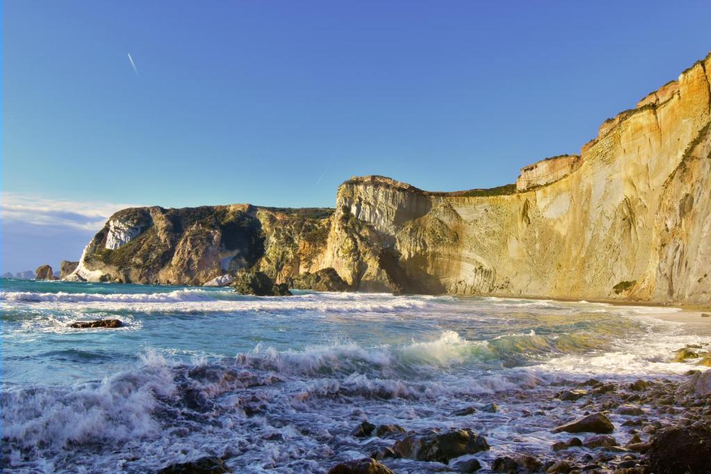a view of a beach with cliffs and the ocean at Chiaia Apartments by Caseaponza it in Ponza