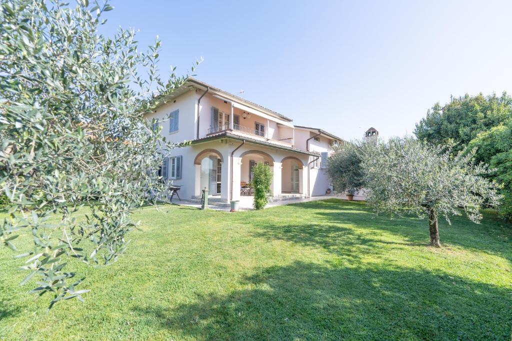 a large white house with trees in the yard at Villa La Corte in Cesa
