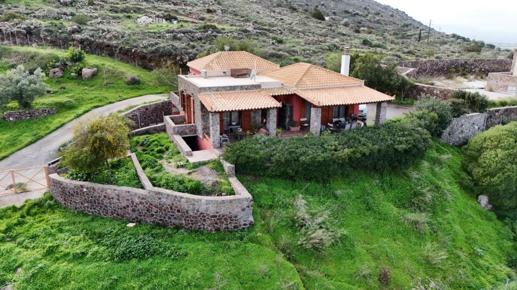 an aerial view of a house on a hill at Red House Retreat Aegina Kontos in Kondós