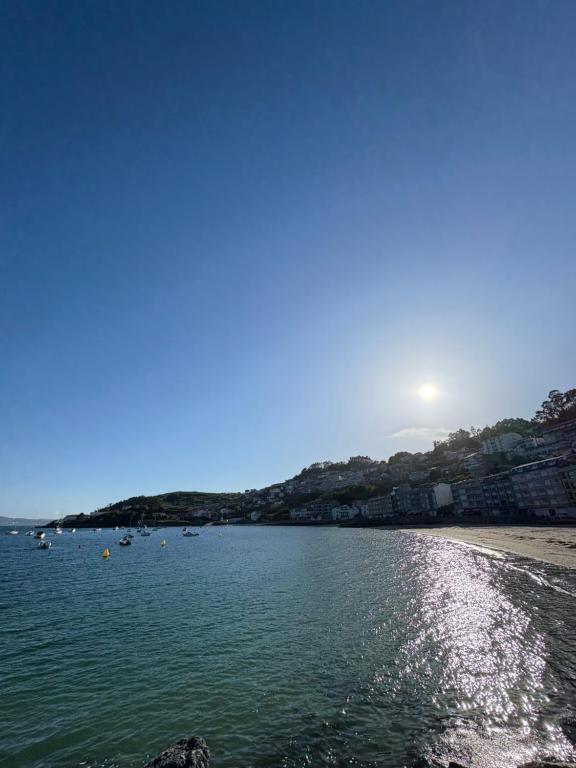 a view of a beach with boats in the water at El paraíso in Raxó