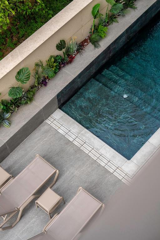 an overhead view of a swimming pool with two lounge chairs at The Marni Hotel & Spa - Adults Only 12 Plus in Antalya