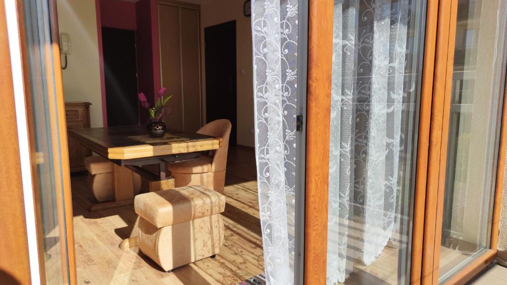 a view of a room with a table and a window at Apartament Ziołowy in Augustów