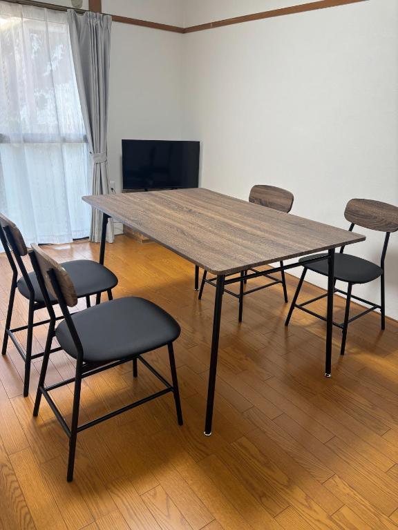 a wooden table and chairs in a room at Seaside accommodation - Vacation STAY 22044 in Horiechō