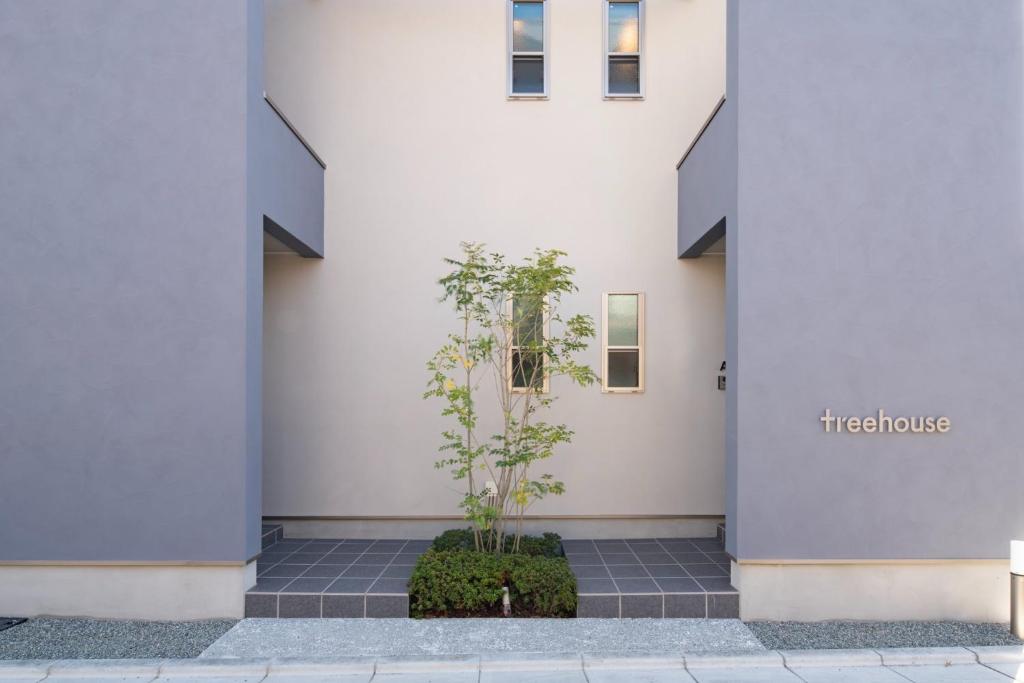 a building with a plant in front of it at treehouse - Vacation STAY 22128 in Nagoki