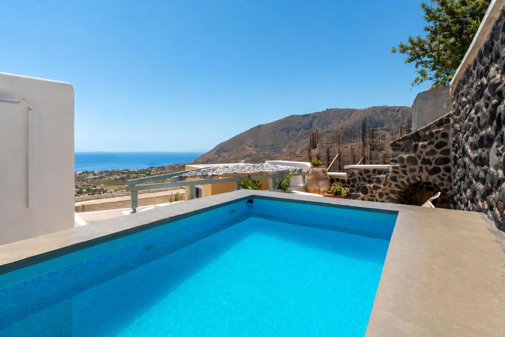 a swimming pool in a villa with a view at Blue Vine Villa - Private Pool - Panoramic Sea View in Kamari