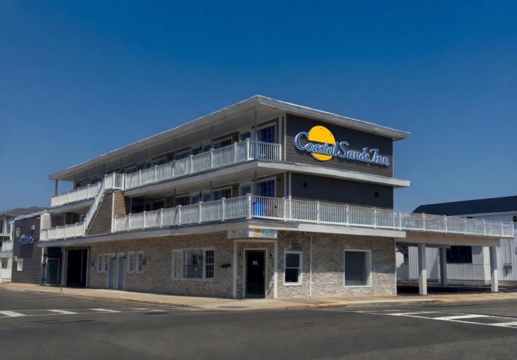 a large building with a sandwich firm sign on it at Coastal Sands Inn in Wildwood