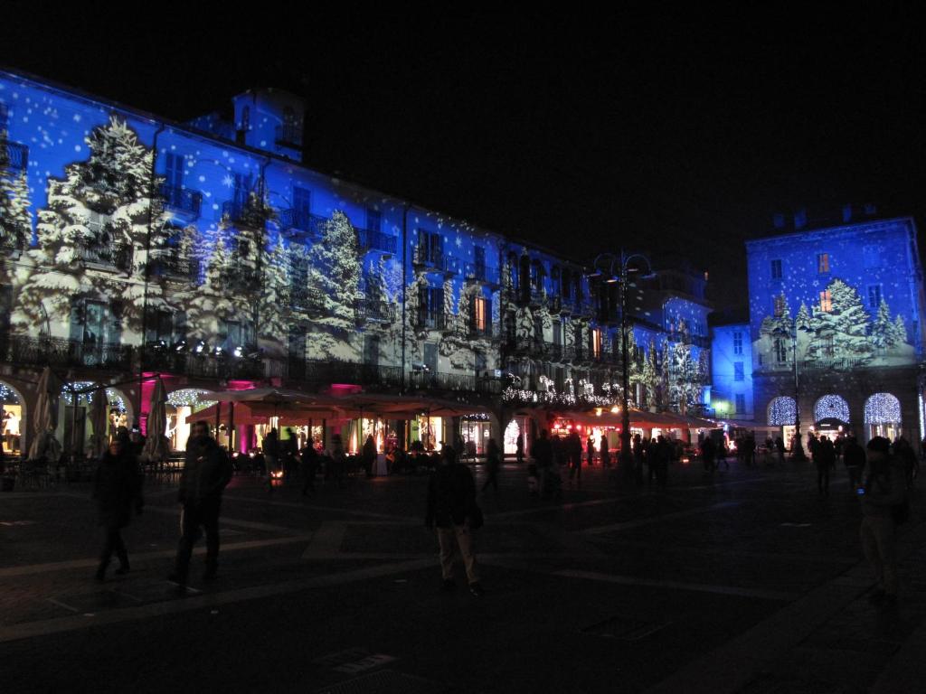 a building with christmas lights on it at night at Como Luxury Rooms in Como