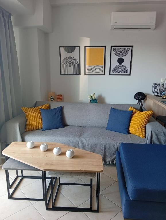 a living room with a couch and a coffee table at Skala Central Comfort Apartment in Skála