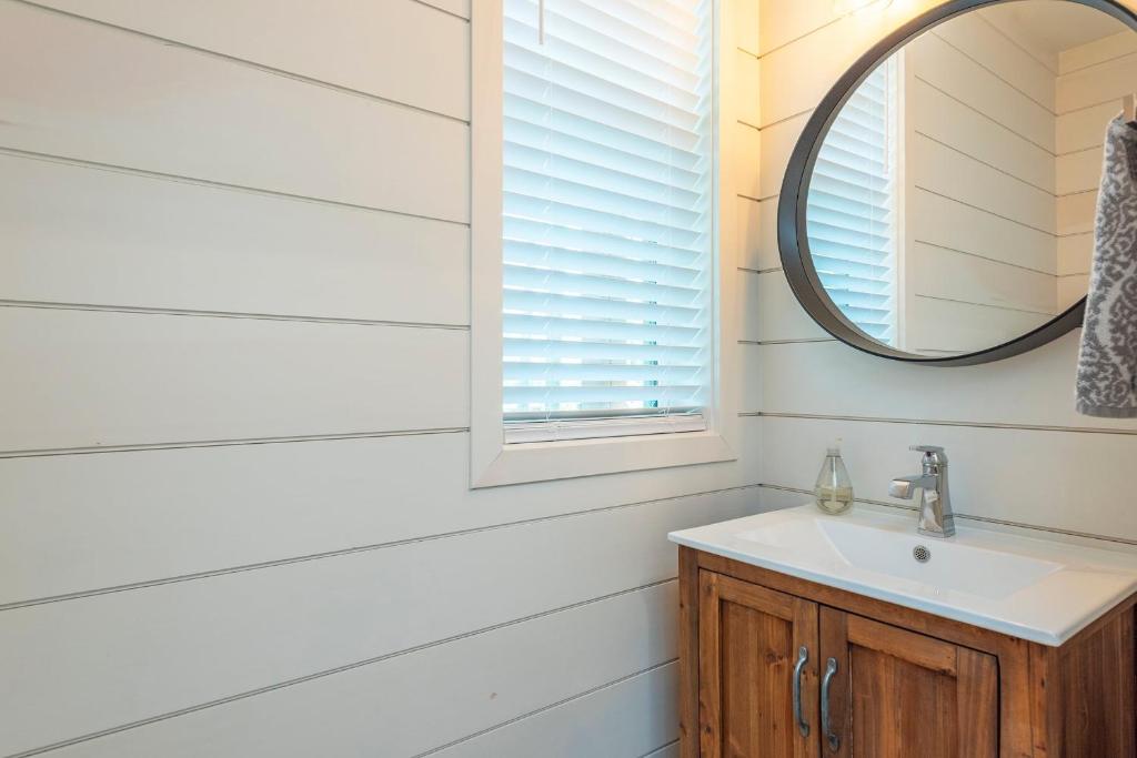 a bathroom with a sink and a mirror at Lake Walk Cottage in Black Mountain
