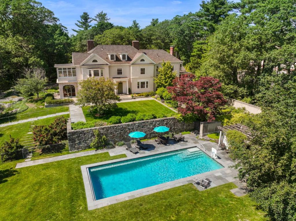 an aerial view of a house with a swimming pool at Executive Boston Estate Pool Mid Term Stays in Dedham
