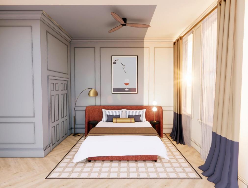 a bedroom with a bed and a ceiling at Hotel Orlo in Greensboro