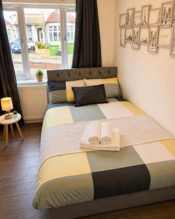 a bedroom with a bed with towels on it at Cosy Double Room in London Free Parking Private Bathroom Close to Transport in Belvedere