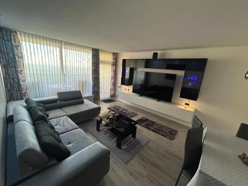 a living room with a couch and a flat screen tv at Ferienglück Geyersberg in Freyung