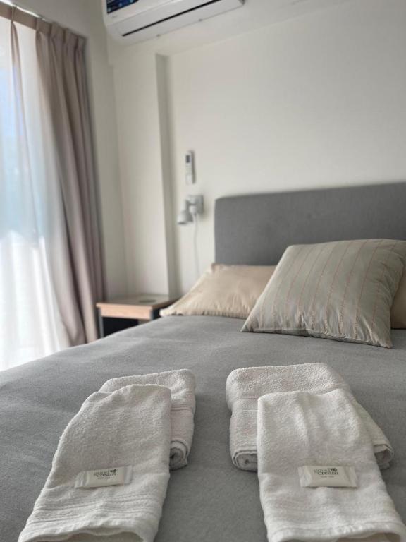 a bed with two towels on top of it at Depto Monroe 2 in Buenos Aires