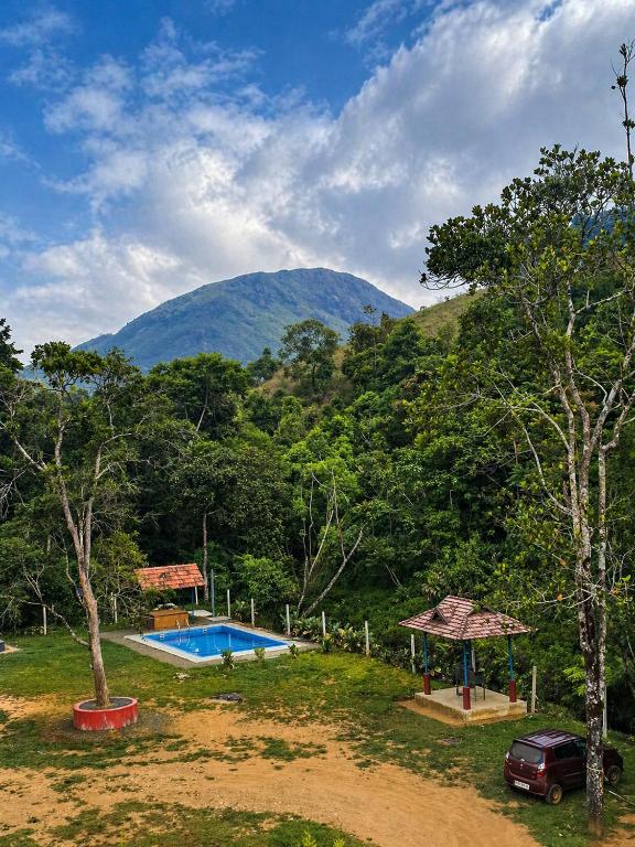a house with a swimming pool and a mountain at Private Pool Villa Vagamon in Vagamon