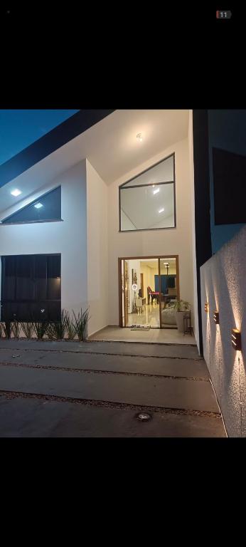 a house with a large window and a dining room at Casa moderna em Itapoá SC in Itapoa