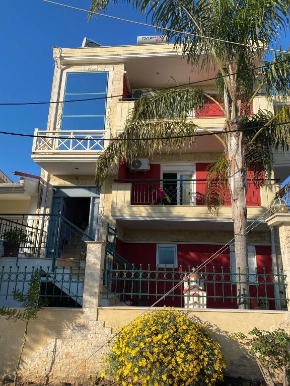 a building with a palm tree in front of it at SONIA in Kallithea Halkidikis
