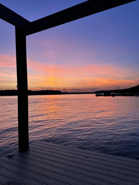 a view of the water from a dock at sunset at Waterfront Cottage, Fiery Sunsets in Charlotte