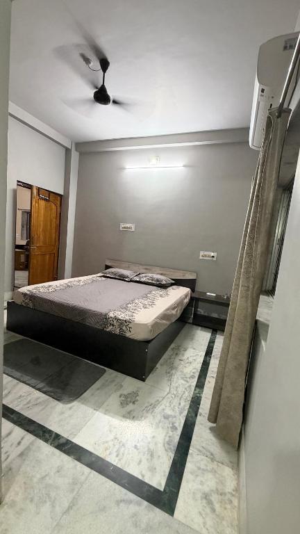 a bedroom with a bed and a ceiling fan at Cozy Cove 3BHK in Cuttack