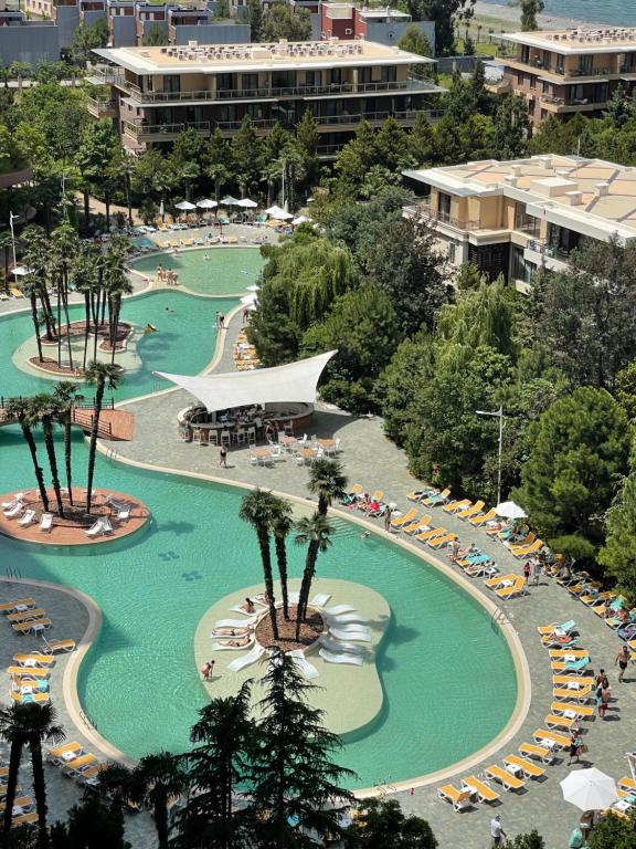 an overhead view of a large swimming pool with people in it at Dreamland Aparts in Chakvi