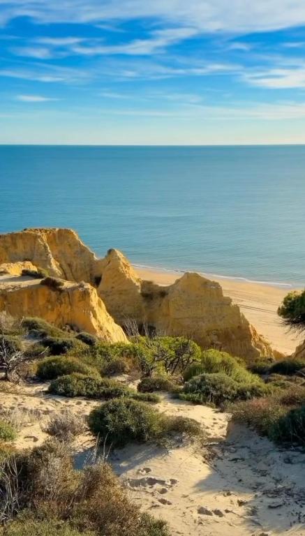 a beach with rocks and the ocean in the background at Apartamentos Amy 5 in Huelva