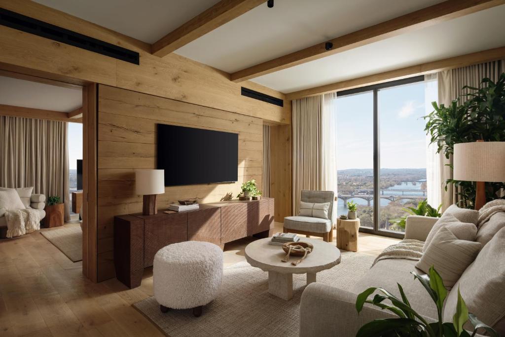 a living room with a couch and a tv at 1 Hotel Austin in Austin
