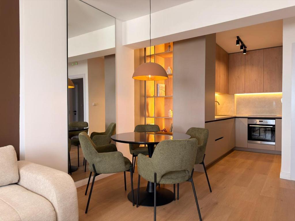 a kitchen and dining room with a table and chairs at Marea Apartment in Bar