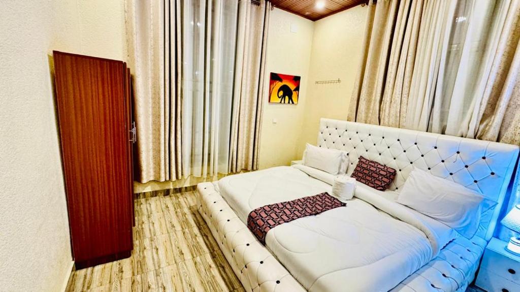 a room with a white bed in a room at Montana Stay B&B in Ruhengeri