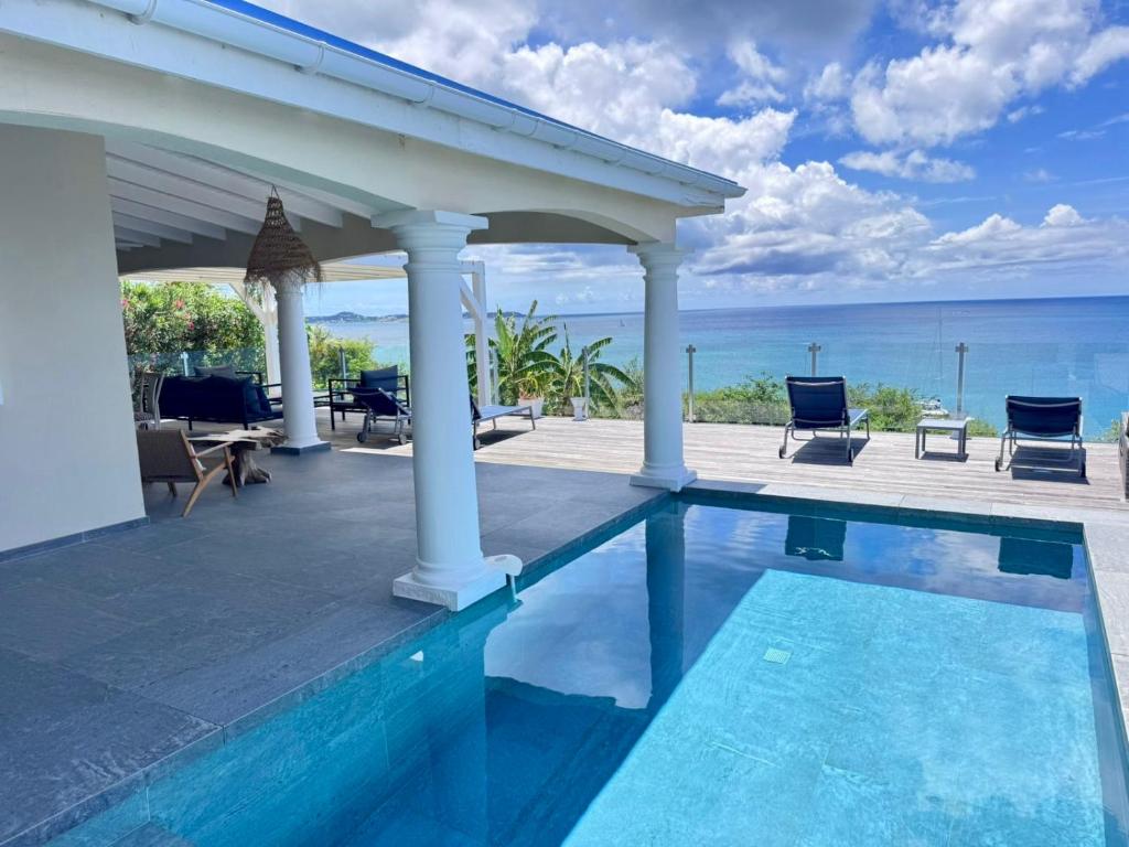 a house with a swimming pool and a gazebo at Villa d'Happy Bay - Panoramic View of Caribbean and sunsets in Friar's Bay