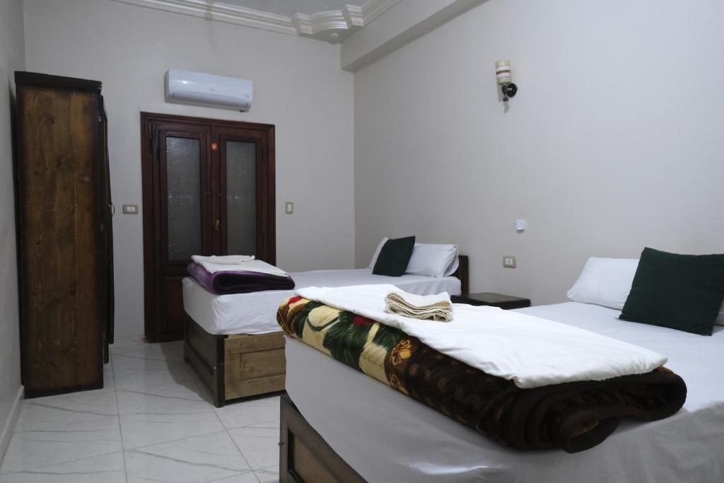 a room with two beds in a room at Al-Manara Hostel Siwa Oasis 2 in Siwa