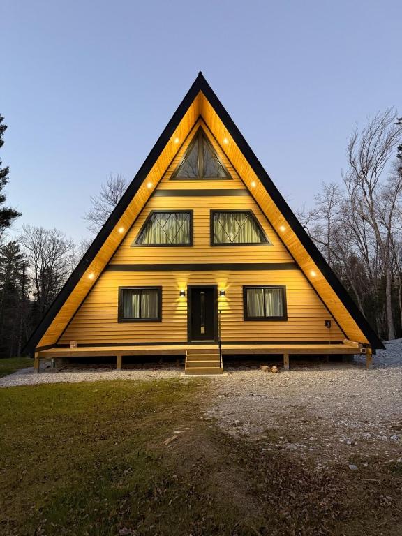 a large yellow house with a triangular roof at Green Mountain Yay Frame in Killington