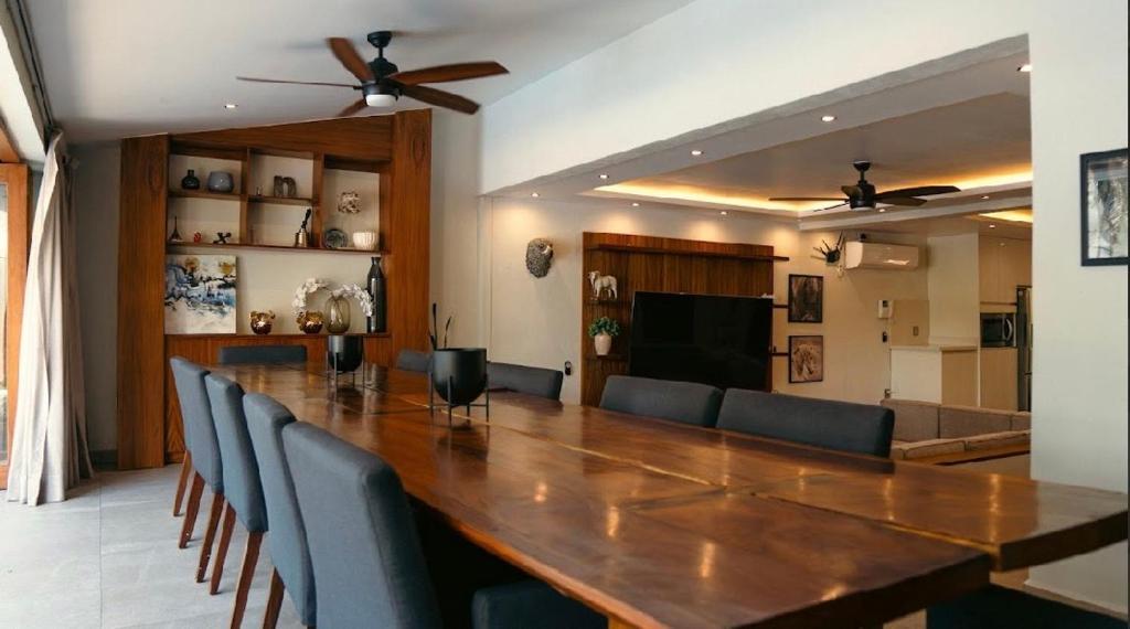 a dining room with a large wooden table and chairs at Quinta San Ignacio in Guadalajara