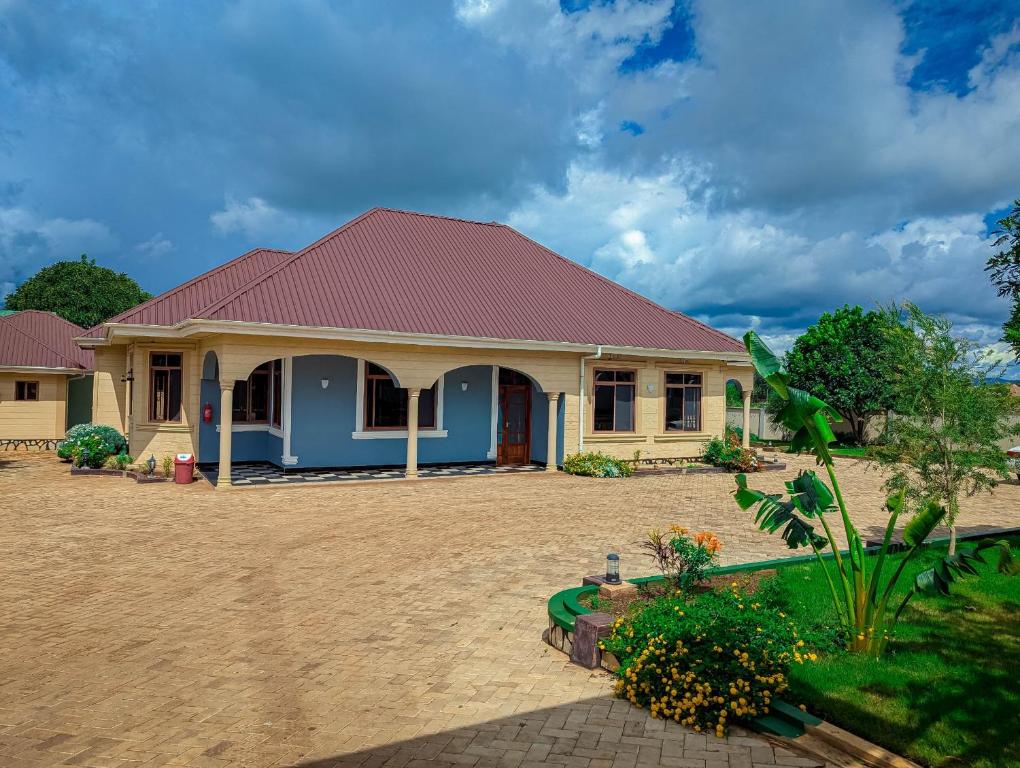 a house with a red roof at New Harambee Hotel in Nakwa
