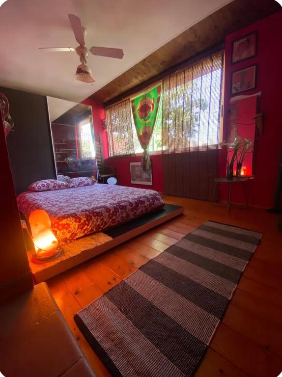 a bedroom with red walls and a bed and a rug at Casa Roberta a due passi dal mare in Quartu Sant'Elena