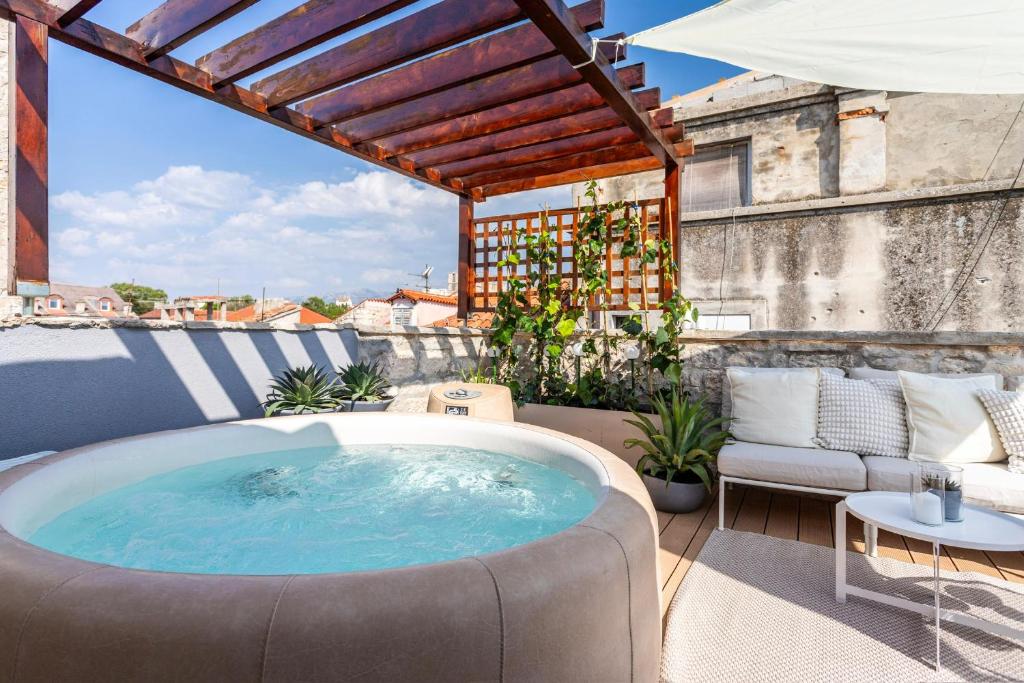 a hot tub sitting on top of a patio at Apartment Luxury Palace No1 in Split
