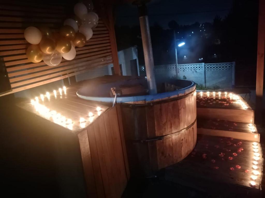 a hot tub in a wooden barrel with lights at Tinajas martina in Las Cruces