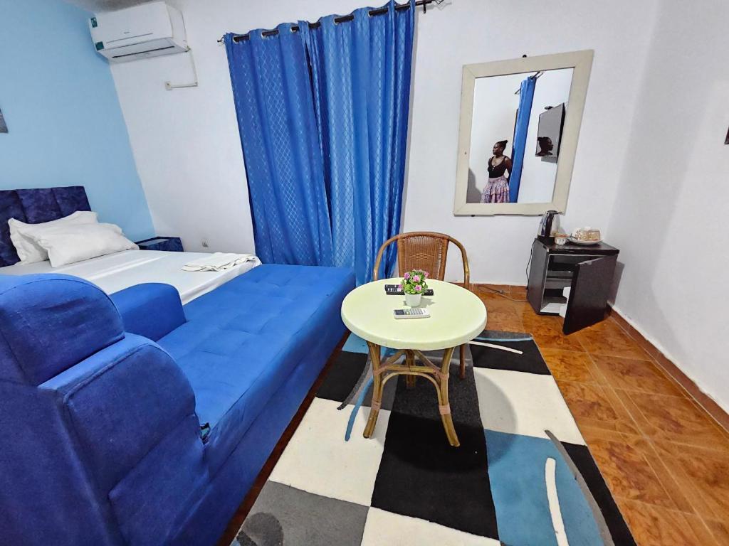 a room with a blue couch and a table at Vince Saly in Saly Portudal