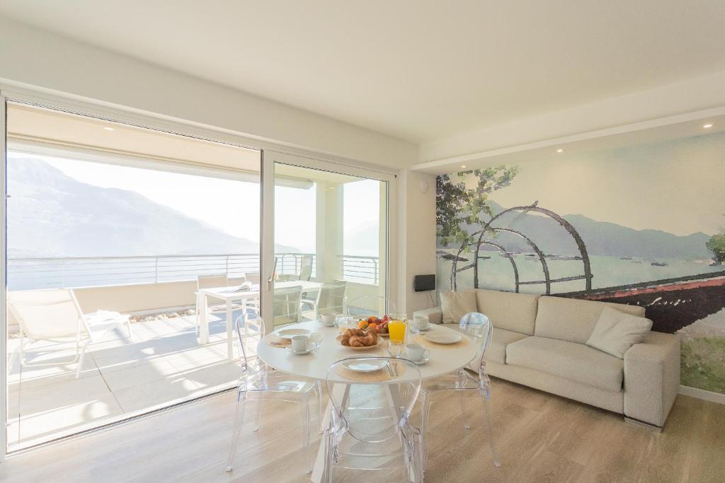 a living room with a table and a couch at Valarin Residence & Villa Valarin Elite by Rent All Como in Vercana