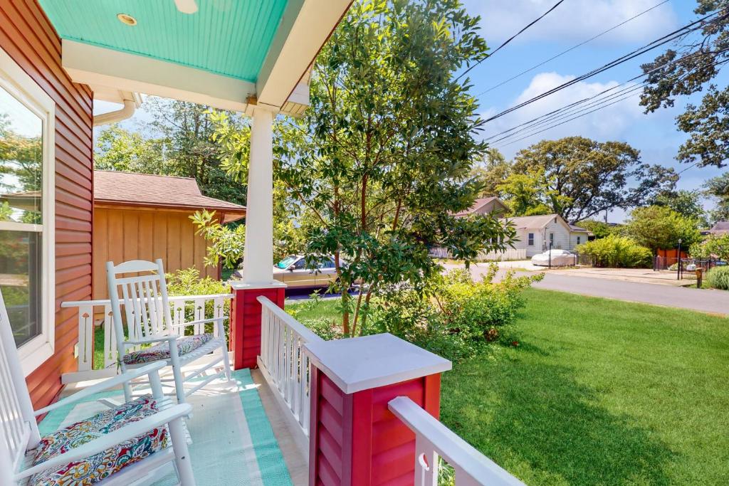 a porch with two white chairs on a house at Anchors Aweigh in Edgewater