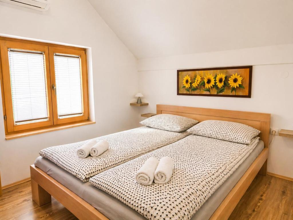 a bedroom with a bed with two towels on it at Airport Studio Loft - Galleria in Belgrade